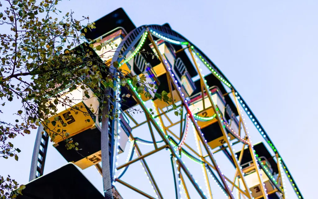 A Ferris wheel at a summer fair at night