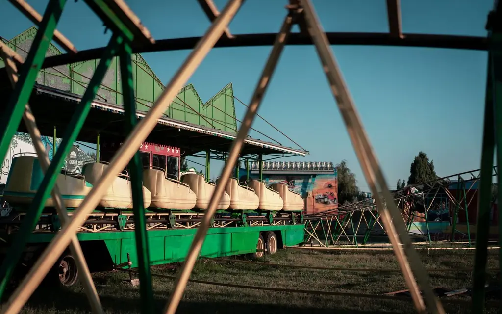 A wooden roller coaster at a summer fair
