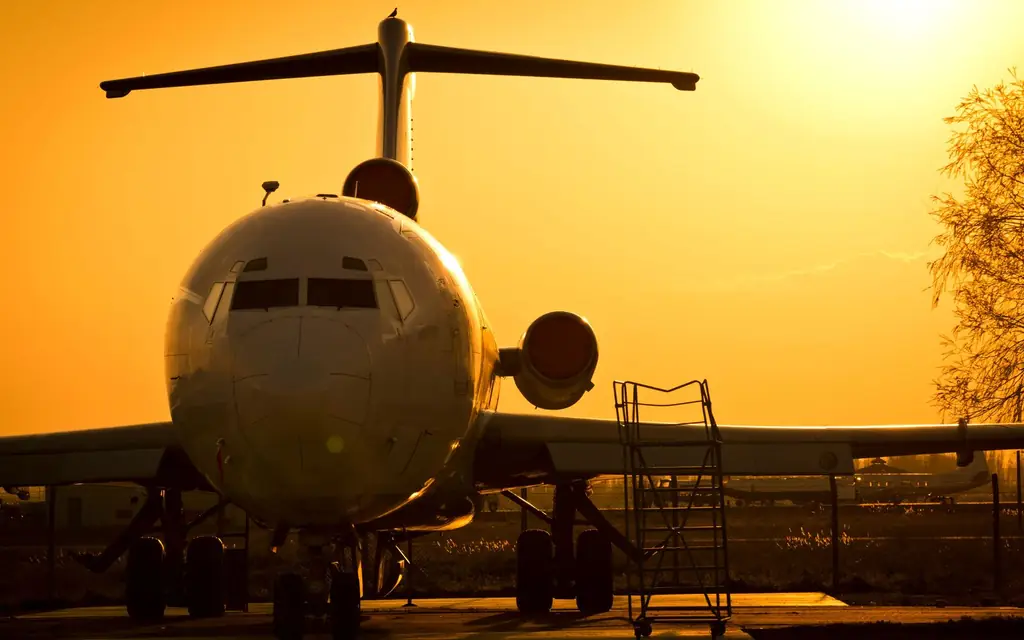 Aircraft silhouetted at sunset on the apron