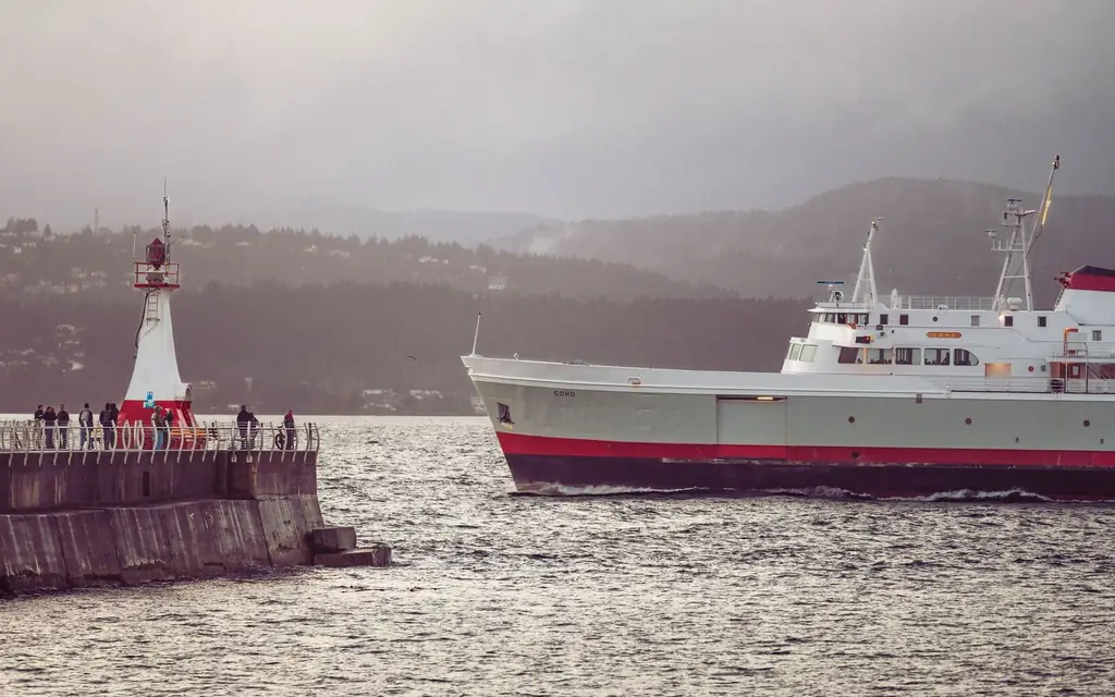A ferry passing the breakwater lighthouse in Victoria