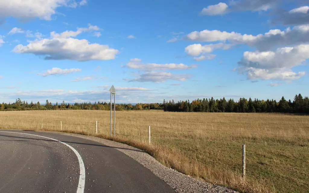 A rural highway through farm fields
